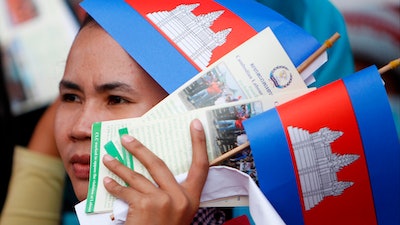 In this May 1, 2018, file photo, a worker participates during a gathering to mark May Day at Tonle Sap river bank, in Phnom Penh, Cambodia. Cambodia's government announced Friday it is raising the minimum wage for the garment industry, the country's biggest export earner, whose workers make up a powerful political bloc.