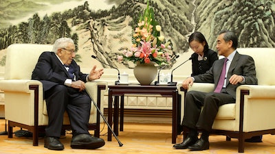 Chinese Foreign Minister Wang Yi meets former U.S. Secretary of State Henry Kissinger at the Great Hall of the People in Beijing on Friday, Nov. 22.