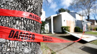 Red 'danger' tape circles a damaged home on Bridgeland Lane in Houston, Sunday, Jan. 26, 2020, after the Watson Grinding Manufacturing explosion early Friday morning.