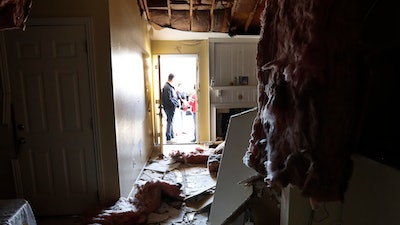 Houston Fire Chief Samuel Peña talks with Hortensia Lima, whose home was seriously damaged and deemed uninhabitable on Stanford Court in Houston, Sunday, Jan. 26, 2020, after the Friday morning explosion at the Watson Grinding Manufacturing plant.