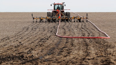 In this Oct. 31, 2018, photo, manure is injected into a field on the Gary Sovereign farm, in Lawler, Iowa. Farmers say they're trying to reduce the smells. 'I've never lived on a farm that didn't have nature's fragrances on it,' said Sovereign, a fifth-generation swine producer in Iowa's Howard County.