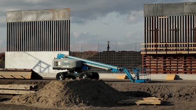 In this Nov. 7, 2019 file photo, the first panels of levee border wall are seen at a construction site along the U.S.-Mexico border, in Donna, Texas. The Trump administration said Tuesday, Feb. 18, 2020, that it will waive federal contracting laws to speed construction of the border wall with Mexico.