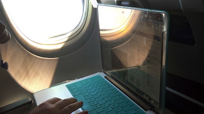 A passenger uses a laptop aboard a commercial airline flight from Boston to Atlanta on July 1, 2017. Concern about new high-speed wireless service interfering with airplanes appears to be easing. Federal safety regulators said Friday, Jan. 28, 2022 they have cleared the way for Verizon and AT&T to turn on more 5G towers.