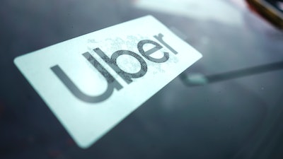 An Uber sign is displayed inside a car in Palatine, Ill., Thursday, Feb. 10, 2022.