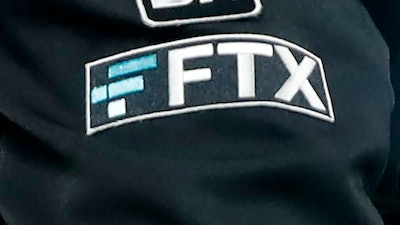 The FTX logo appears on home plate umpire Jansen Visconti's jacket at a baseball game with the Minnesota Twins on Tuesday, Sept. 27, 2022, in Minneapolis.