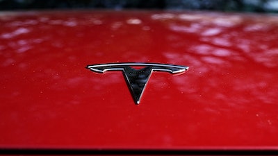 A Tesla logo is seen on a vehicle on display in Austin, Texas, Wednesday, Feb. 22, 2023.