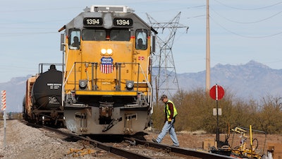 The crew on a Union Pacific freight train works at a siding area on Jan. 24, 2020, south of Tucson, Ariz.