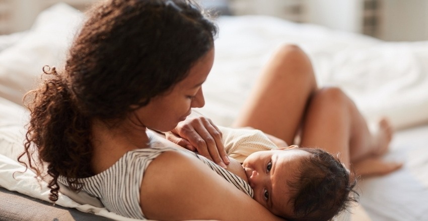 baby using breast as pacifier