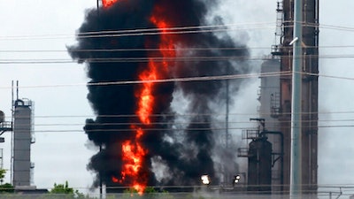 Flames and smoke rise after a fire started at an Exxon Mobil facility, Wednesday, July 31, 2019, in Baytown, Texas.