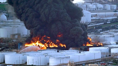 In this Monday, March 18, 2019 file photo, Firefighters battle a petrochemical fire at the Intercontinental Terminals Company in Deer Park, Texas. A fire at a Houston-area petrochemical storage facility that burned for days in March was accidental and caused by equipment failure at a storage tank, according to a report released by local and federal investigators, Friday, Dec. 6, 2019.