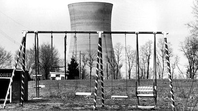 This March 30, 1979, file photo shows a cooling tower of the Three Mile Island nuclear power plant near Harrisburg, Pa., as it looms behind an abandoned playground. Forty years after Three Mile Island became synonymous with America's worst commercial nuclear power accident, the prospect of bailing out nuclear power plants is stirring debate at the highest levels of Pennsylvania and the federal government.