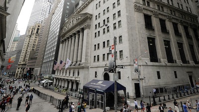 In this file photo pedestrians pass the New York Stock Exchange in New York.