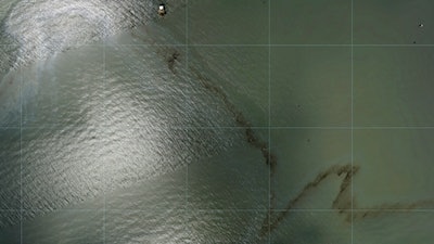 Photos captured by National Oceanic and Atmospheric Administration aircraft Tuesday, Aug. 31, 2021 and reviewed by The Associated Press show a miles long black slick floating in the Gulf of Mexico near a large rig marked with the name Enterprise Offshore Drilling.