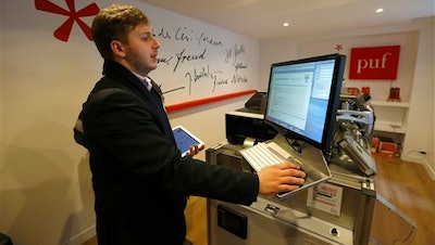 French publishing house Les Presses Universitaires de France (PUF) project manager Alexandre Gaudefroy, works on the Espresso Book Machine at the PUF bookstore in Paris. To many Parisians, the letters PUF have always been associated with the intellectual heart of the French capital.