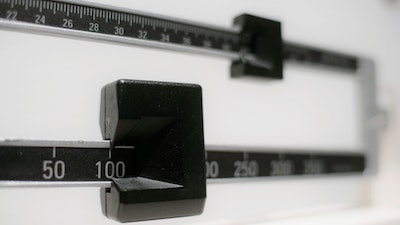 This Tuesday, April 3, 2018 photo shows a closeup of a beam scale in New York. A report released on Wednesday, Dec. 18, 2019 says nearly half of American adults will be obese within a decade and one-quarter will be severely so.
