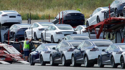 Tesla cars are loaded onto carriers at the Tesla electric car plant on May 13, 2020, in Fremont, Calif. Tesla is recalling nearly 363,000 vehicles with its “Full Self-Driving” system to fix problems with the way it behaves around intersections and following posted speed limits, the National Highway Traffic Safety Administration announced Thursday, Feb. 16, 2023.