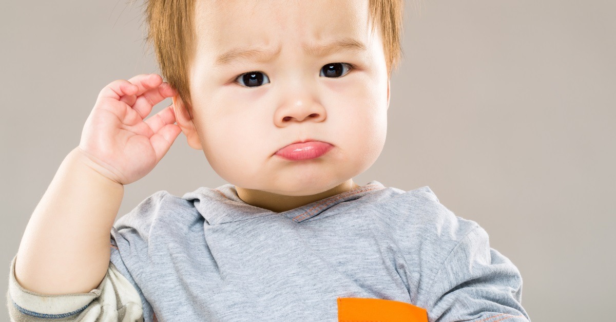 toddler hits the side of his head