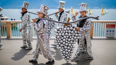 People take part of the 'Fete des Vignerons' (winegrowers' festival in French), parade during the official opening parade prior to the first representation and crowning ceremony in Vevey, Switzerland.